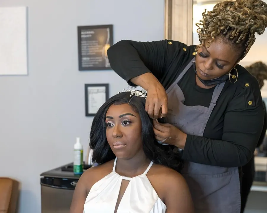 Finishing touches on a bride's hair and makeup