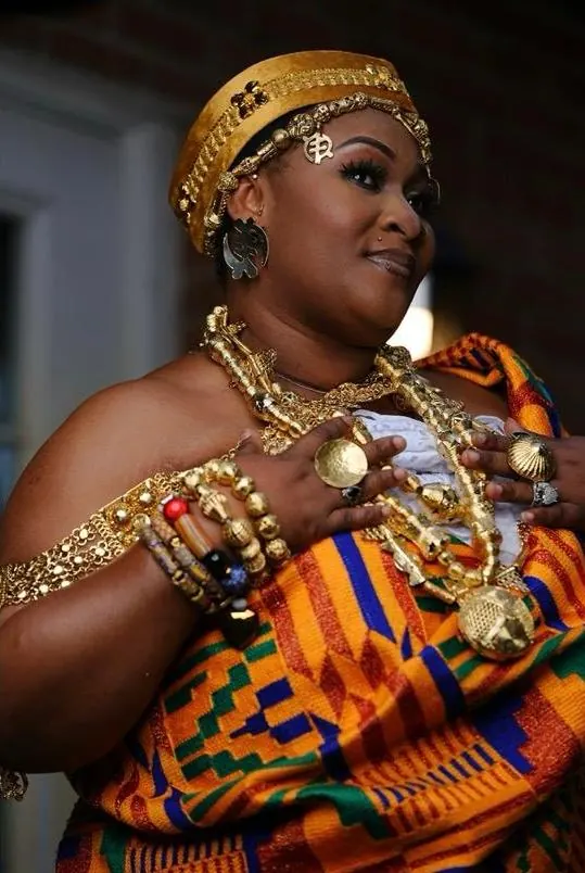 Traditional wedding glam in orange and gold kente